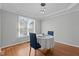 Eat-in kitchen features a tray ceiling, modern lighting, hardwood floors, and window views at 5313 Wenesly Ct, Raleigh, NC 27616
