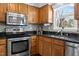 Modern kitchen with stainless steel appliances, granite countertops, and ample wood cabinetry at 5313 Wenesly Ct, Raleigh, NC 27616