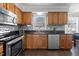 Updated kitchen features stainless appliances, granite countertops, and tile backsplash at 5313 Wenesly Ct, Raleigh, NC 27616