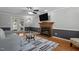 Cozy living room with a fireplace, ceiling fan, hardwood floors, and French doors to the deck at 5313 Wenesly Ct, Raleigh, NC 27616