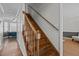 Traditional staircase with hardwood steps, wooden railings, and white risers and trim at 5313 Wenesly Ct, Raleigh, NC 27616