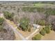 Aerial shot of a home surrounded by woods and a road nearby at 5408 Rivercrest Dr, Youngsville, NC 27596