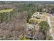 Aerial view of a house among trees with other homes nearby at 5408 Rivercrest Dr, Youngsville, NC 27596