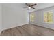 Cozy bedroom features ample natural light, ceiling fan, modern floors, and a comfortable atmosphere at 5408 Rivercrest Dr, Youngsville, NC 27596