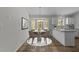 Dining area featuring a bay window, stylish chandelier, and seamless transition to the modern kitchen at 5408 Rivercrest Dr, Youngsville, NC 27596