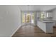 Dining area featuring a bay window, stylish chandelier, and seamless transition to the modern kitchen at 5408 Rivercrest Dr, Youngsville, NC 27596
