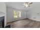 Inviting living room features fireplace, fan, neutral walls and a window with a view to the backyard at 5408 Rivercrest Dr, Youngsville, NC 27596