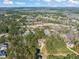 Expansive aerial view of a luxury home nestled within a lush, green landscape and community at 56 Mist Wood Ct, Pittsboro, NC 27312