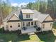 Aerial view of the home and property showcasing the back patio, manicured lawn, and trees at 56 Mist Wood Ct, Pittsboro, NC 27312