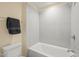 Bathroom featuring a tiled shower over tub and a toilet with a gray hand towel at 56 Mist Wood Ct, Pittsboro, NC 27312