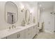 Bright bathroom with double vanity, quartz countertops, gold hardware, and tiled walk-in shower at 56 Mist Wood Ct, Pittsboro, NC 27312