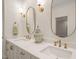Elegant bathroom with double sinks, quartz countertops, and gold fixtures at 56 Mist Wood Ct, Pittsboro, NC 27312