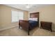 Bedroom with carpet, an antique bed with dark wood frame, neutral paint, and window at 56 Mist Wood Ct, Pittsboro, NC 27312