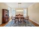 Formal dining room with decorative rug, natural light, and classic furniture at 56 Mist Wood Ct, Pittsboro, NC 27312