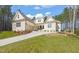 Beautiful exterior view of home featuring a brick facade, well-manicured lawn and landscaping at 56 Mist Wood Ct, Pittsboro, NC 27312
