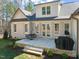 Rear exterior with a brick patio, outdoor furniture, grill, and manicured lawn at 56 Mist Wood Ct, Pittsboro, NC 27312