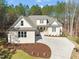 A beautiful shot of the home's exterior elevation, with landscaping and a circular driveway at 56 Mist Wood Ct, Pittsboro, NC 27312