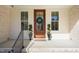 Charming front porch featuring decorative plants and a wooden door at 56 Mist Wood Ct, Pittsboro, NC 27312