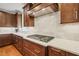 Modern kitchen with white counters, marble backsplash, and stainless steel gas cooktop at 56 Mist Wood Ct, Pittsboro, NC 27312
