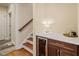 Wine bar features a wine cooler, countertop, storage cabinets, and nearby staircase at 56 Mist Wood Ct, Pittsboro, NC 27312