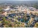 Aerial view showcases a neighborhood near commercial development and landscape of lush, mature trees at 5624 Bennettwood Ct, Raleigh, NC 27612