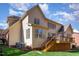 Rear exterior showcasing a well-maintained lawn, wood deck, and the home's siding under a bright sky at 5624 Bennettwood Ct, Raleigh, NC 27612