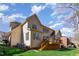 Rear exterior showcasing a well-maintained lawn, wood deck, and the home's siding under a bright sky at 5624 Bennettwood Ct, Raleigh, NC 27612