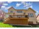 Expansive backyard view featuring a raised deck and lush green lawn beneath a partly cloudy sky at 5624 Bennettwood Ct, Raleigh, NC 27612