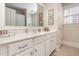 Bright bathroom vanity with a large mirror and white cabinetry at 5624 Bennettwood Ct, Raleigh, NC 27612