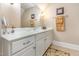 Bathroom features a white vanity with marble countertop, a mirror, and beige-colored walls with a towel rack at 5624 Bennettwood Ct, Raleigh, NC 27612