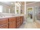 En-suite bathroom with walk-in closet, tiled floor, and & sinks at 5624 Bennettwood Ct, Raleigh, NC 27612
