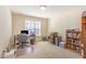Clean carpeted bedroom with a work desk, shelving, and lots of natural light at 5624 Bennettwood Ct, Raleigh, NC 27612