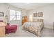 Bedroom featuring light walls, carpeted floor, a floral bedspread, and a chair at 5624 Bennettwood Ct, Raleigh, NC 27612
