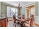 Elegant dining room with a large window for natural light and decorative light fixture overhead at 5624 Bennettwood Ct, Raleigh, NC 27612