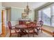 Formal dining room boasts hardwood floors, elegant chandelier, and beautiful carved wood furniture at 5624 Bennettwood Ct, Raleigh, NC 27612