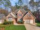 Brick house with a well-manicured lawn, shutters, and two-car garage at 5624 Bennettwood Ct, Raleigh, NC 27612