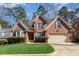 Stunning brick house with a manicured lawn, shutters, and a two-car garage at 5624 Bennettwood Ct, Raleigh, NC 27612