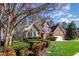 Beautiful brick home featuring lush landscaping, a bay window and mature trees at 5624 Bennettwood Ct, Raleigh, NC 27612