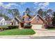 Charming brick home with a manicured lawn, shutters, and a two-car garage at 5624 Bennettwood Ct, Raleigh, NC 27612