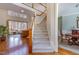 Grand foyer showcasing a staircase, wood floors, and an open living area at 5624 Bennettwood Ct, Raleigh, NC 27612