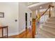 Entrance foyer with hardwood floors, staircase, and view into other rooms at 5624 Bennettwood Ct, Raleigh, NC 27612