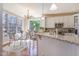 Bright kitchen with white cabinets, breakfast nook, and a granite countertop breakfast bar at 5624 Bennettwood Ct, Raleigh, NC 27612