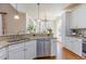 Updated kitchen featuring granite countertops, stainless steel appliances, and lots of natural light at 5624 Bennettwood Ct, Raleigh, NC 27612