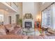 Bright living room features a fireplace, hardwood floors, and large windows at 5624 Bennettwood Ct, Raleigh, NC 27612