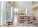 Living room with hardwood floors, a view of the kitchen, and large windows at 5624 Bennettwood Ct, Raleigh, NC 27612