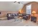 A large section couch anchors this cozy carpeted room with a glass coffee table at 5624 Bennettwood Ct, Raleigh, NC 27612