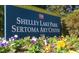 Outdoor sign for Raleigh Parks & Recreation at Shelley Lake Park-Sertoma Art Center with colorful pansies in the foreground at 5624 Bennettwood Ct, Raleigh, NC 27612