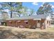 The backyard shows a brick house with awnings over the windows and a storage area at 5630 Jones Sausage Rd, Garner, NC 27529