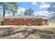 Brick home with backyard, mower and ladder at 5630 Jones Sausage Rd, Garner, NC 27529