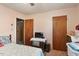 Small bedroom with dated carpet and two wooden doors at 5630 Jones Sausage Rd, Garner, NC 27529